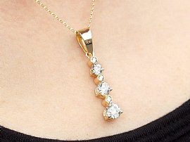 Close up 6 Stone Diamond Drop Pendant in Gold Worn