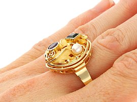 Pearl and Tourmaline Ring in Gold Wearing Finger