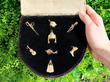 Antique Gold Bracelet Charms in a box outside