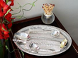 silver cutlery on a salver next to a match striker