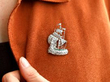 wearing diamond emerald ship brooch