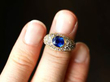 Oval Cut Sapphire and Diamond Ring on finger