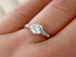 diamond solitaire ring on finger