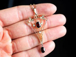 garnet and pearl pendant in gold