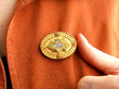 wearing gold brooch