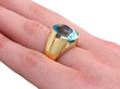 blue topaz yellow gold ring on finger