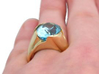 blue topaz yellow gold ring being worn