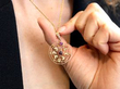 holding amethyst garnet pendant