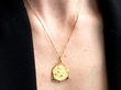 wearing a gold pendant