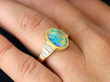 opal and diamond yellow gold ring on finger
