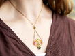 wearing a tourmaline and peridot pendant