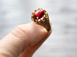 garnet rose gold ring in hand