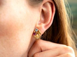 wearing gemstone gold earrings