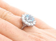 white gold blue topaz ring on finger