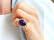 wearing oval cabochon amethyst ring