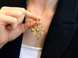holding a pearl and garnet pendant brooch