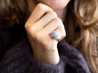 aquamarine and diamond cluster ring being worn