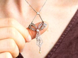 wearing diamond and pearl bow necklace