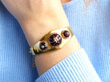 wearing garnet gold bangle