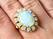 opal and diamond ring on finger