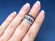 sapphire and diamond rings stacked on finger