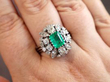 wearing emerald and diamond ring on hand