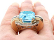 blue topaz and sapphire ring on finger