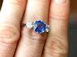 Blue Sapphire and Diamond Trilogy Ring on finger