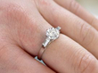 diamond and platinum solitaire ring on hand
