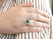wearing emerald and diamond ring