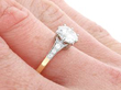 diamond and yellow gold engagement ring on hand