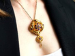 wearing garnet gold tassel pendant