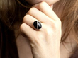 wearing a round onyx ring