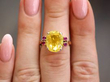 Yellow Sapphire Ring with Rubies in Gold on finger