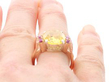 Yellow Sapphire Ring with Rubies in Gold on finger
