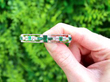 Edwardian Bar Brooch with Emeralds and Diamonds outside