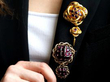 wearing garnet brooches