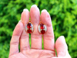 Fire Opal gold earrings outside