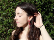 ruby and diamond yellow gold drop earring being worn