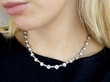 wearing round and baguette cut diamond necklace