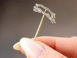 diamond pig brooch in hand