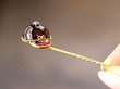 Garnet Jockey Cap Pin in Fingers