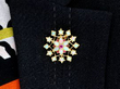Opal and Ruby Floral brooch in Gold wearing