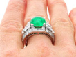 Platinum emerald diamond ring on finger