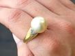 Gold Cultured Pearl and Diamond Ring on finger