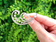 Scrolling Feather Diamond Brooch in Yellow Gold outside
