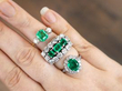 emerald and diamond rings stacked on finger