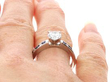 diamond Solitaire Ring with Sapphire and Diamond Shoulders on finger