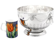 Antique Silver Bowl with Lion Handles next to a mug