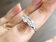 Diamond trilogy ring on finger